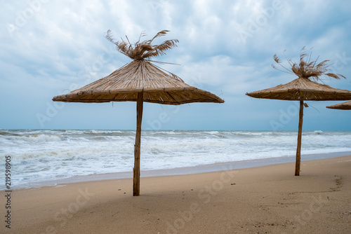 Straw umbrellas on the beach.