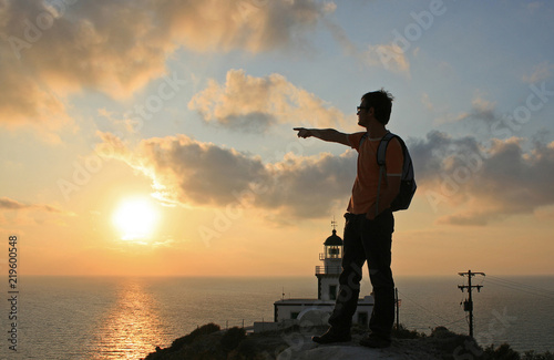 Mediterranean sunset at the Akrotiri Lighthouse in Santorini, Greece. photo