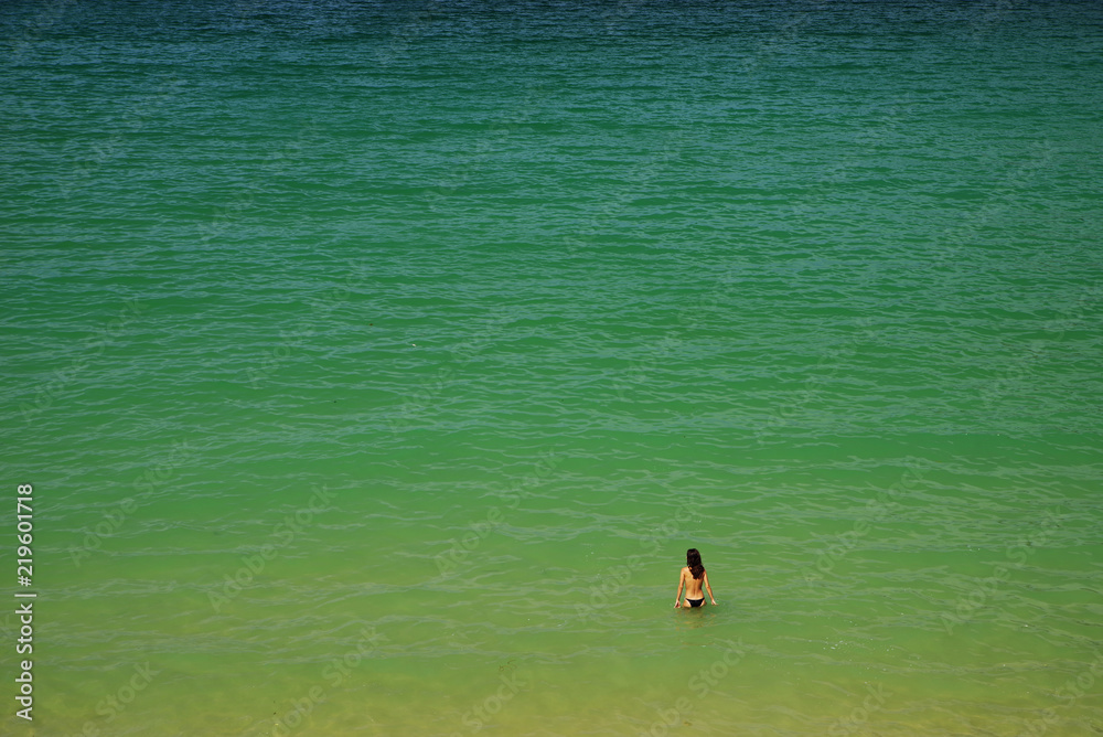 Lonely teenager enjoying the ocean water