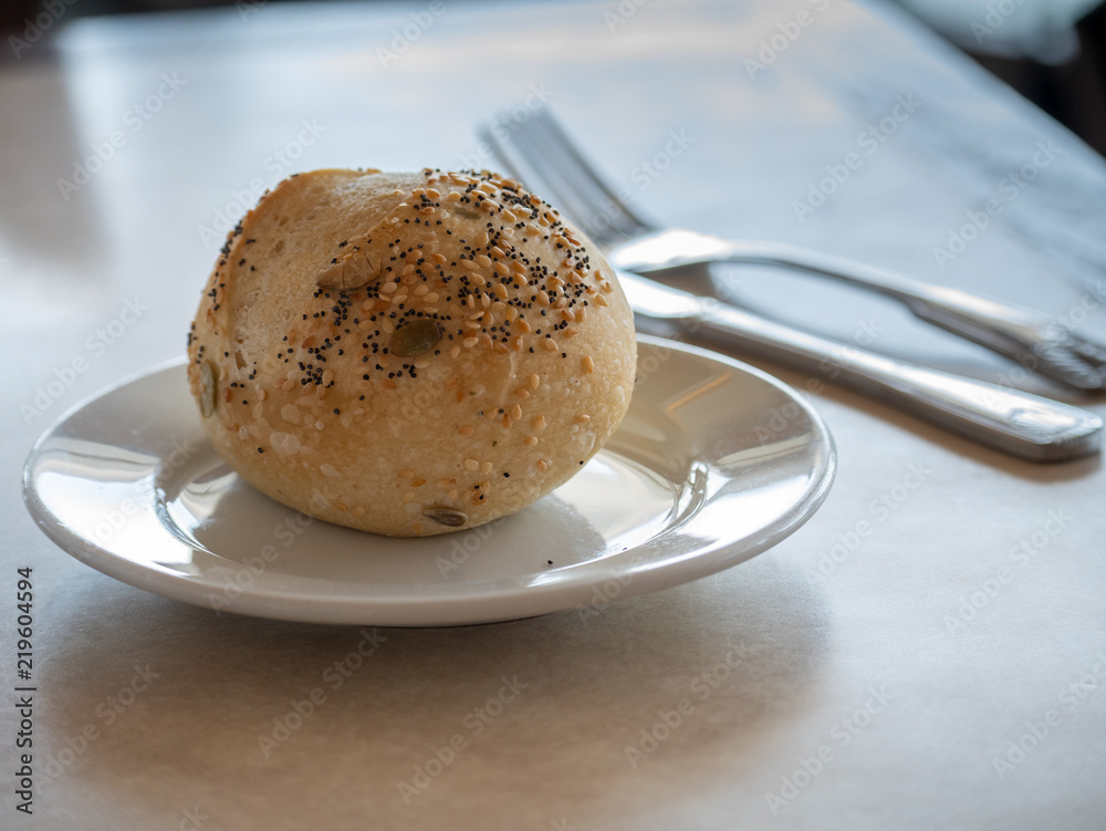 Fototapeta premium Bread With Sesame Seeds on White Plate