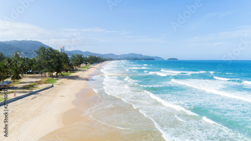 Beautiful wave crashing on sandy shore at karon beach in phuket thailand,aerial view drone shot.