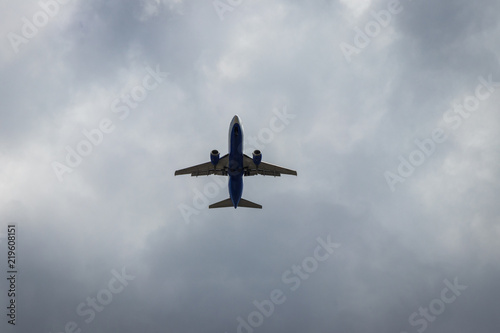 background. defocus. airplane in blue sky with gray and white clouds