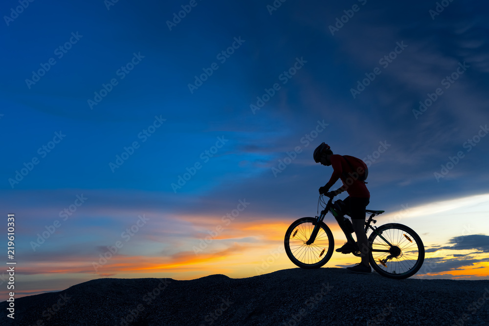 Fototapeta premium Silhouette of cyclist in motion
