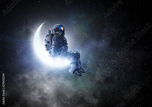 Fototapeta Naklejka Na Ścianę i Meble -  Astronaut sit on crescent moon. Mixed media