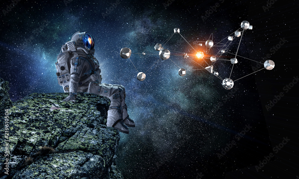 Fototapeta premium Spaceman on rock edge. Mixed media