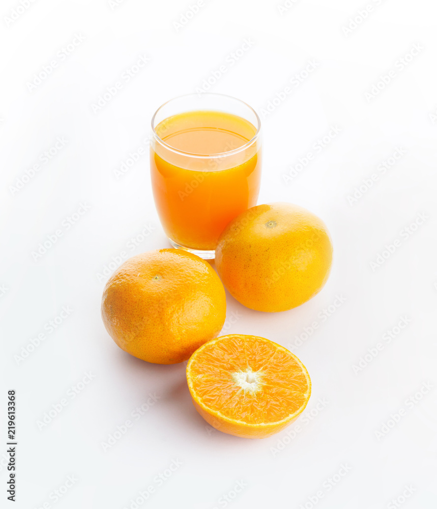 A glass of orange juice and an oranges isolated on white background A glass of orange juice and an oranges isolated on white background