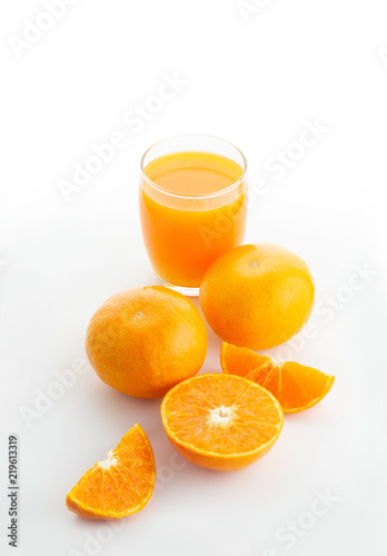 A glass of orange juice and an oranges isolated on white background 
