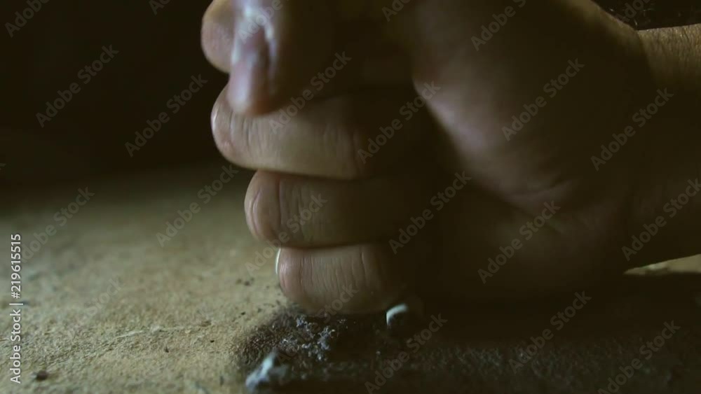The man put out the cigarette by hands The man put out the cigarette by hands