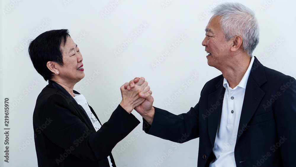 Happy smile Asian elderly couple in business attire, SME owner Happy smile Asian elderly couple in business attire, SME owner
