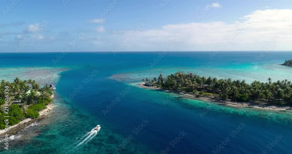 small island in a lagoon with a motor boat small island in a lagoon with a motor boat