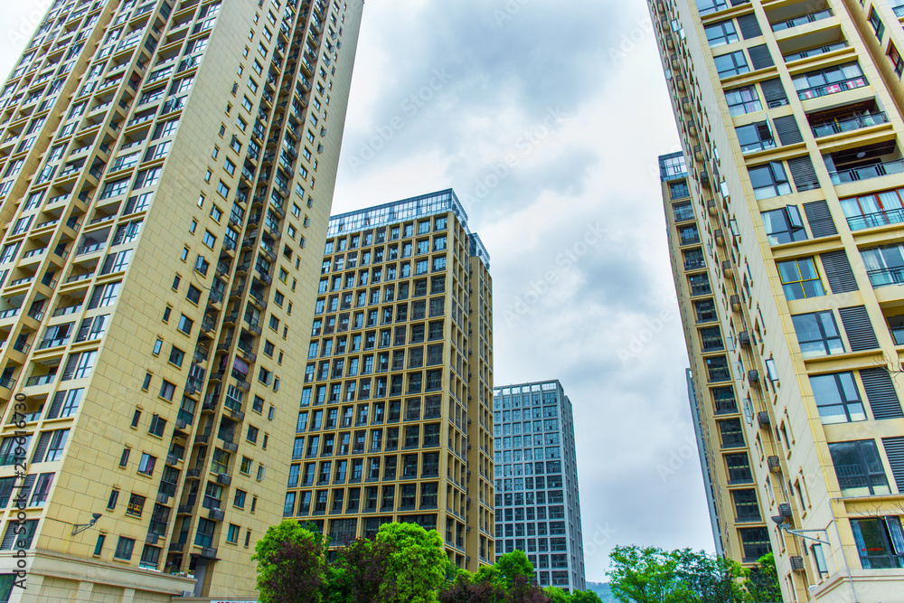 Looking up at the high-rise residential buildings in the city Looking up at the high-rise residential buildings in the city
