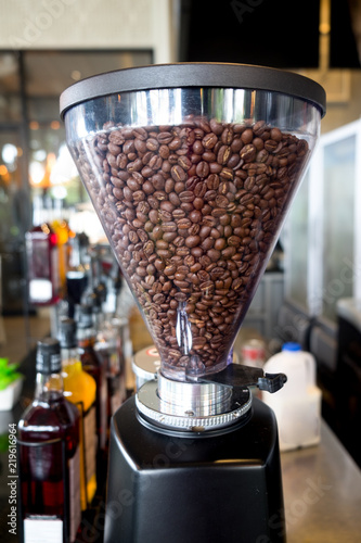 Coffee grinder fully with roasted coffee beans © Dontree