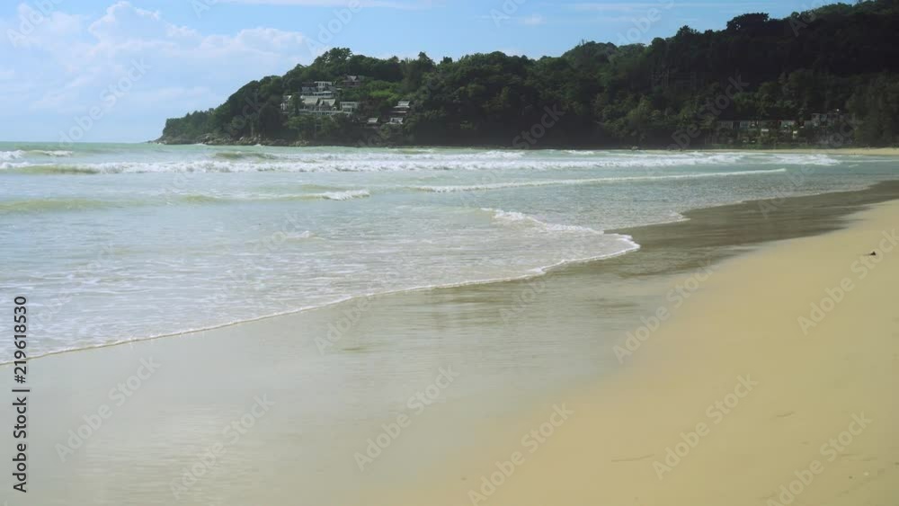 Tropical beach wave and sand and rocks with summer blue sky Tropical beach wave and sand and rocks with summer blue sky