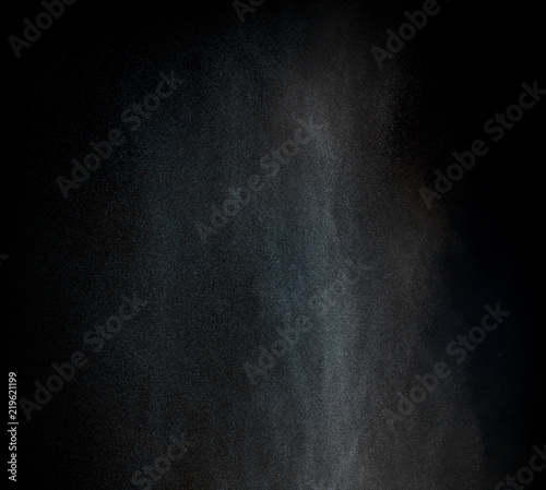Dust particles over black background