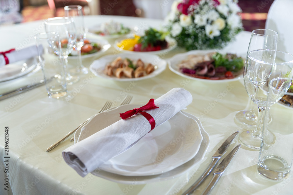 Wedding decorated table. Luxury light decor on table in restaurant Wedding decorated table. Luxury light decor on table in restaurant