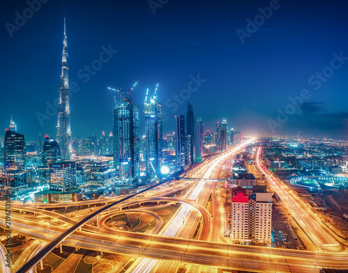 Colourful nighttime skyline of Dubai, United Arab Emirates. Travel background.