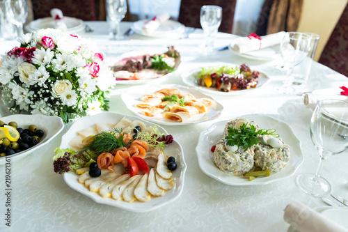 Wedding decorated table. Luxury light decor on table in restaurant 