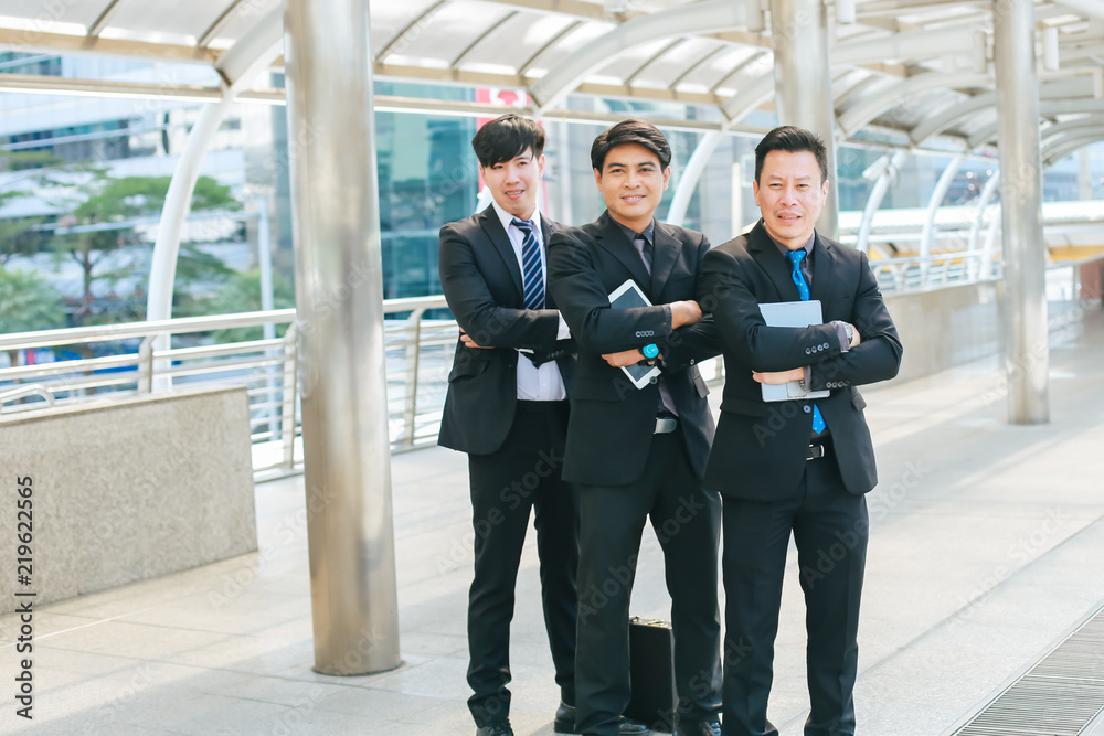 Businessmen confidently stood smiling with success in they work.They can work together and succeed very well. Businessmen confidently stood smiling with success in they work.They can work together and succeed very well.