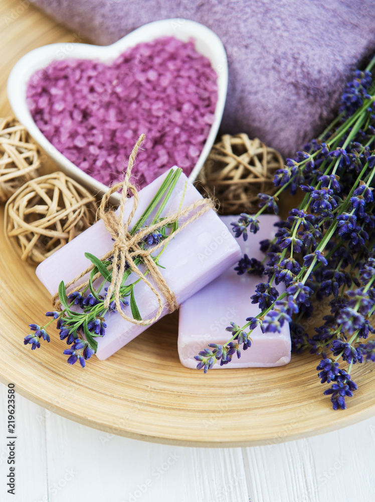 Heart-shaped bowl with sea salt, soap and fresh lavender flowers Heart-shaped bowl with sea salt, soap and fresh lavender flowers