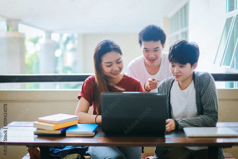 Groups of young people who are prepared to do the exam at the end of the summer, with school books on the table.Student group and education concept. Groups of young people who are prepared to do the exam at the end of the summer, with school books on the table.Student group and education concept.