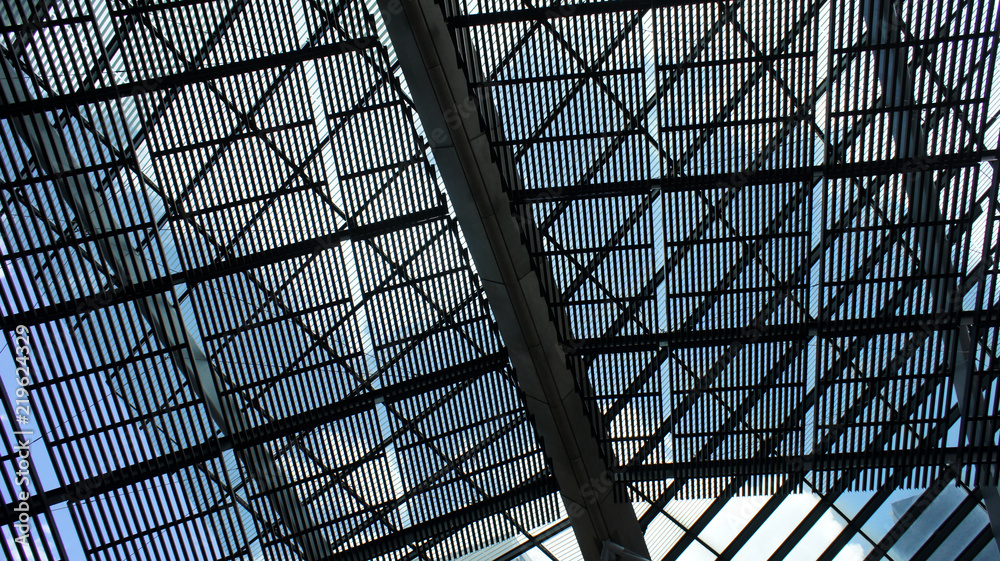 Large pergola sunshade made of metal against blue sky Large pergola sunshade made of metal against blue sky