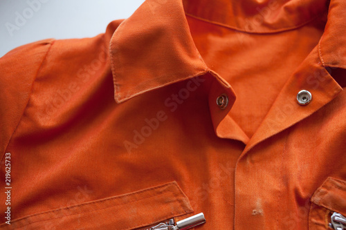 An orange jumpsuit of a prisoner. Serving of compulsory execution of court decisions