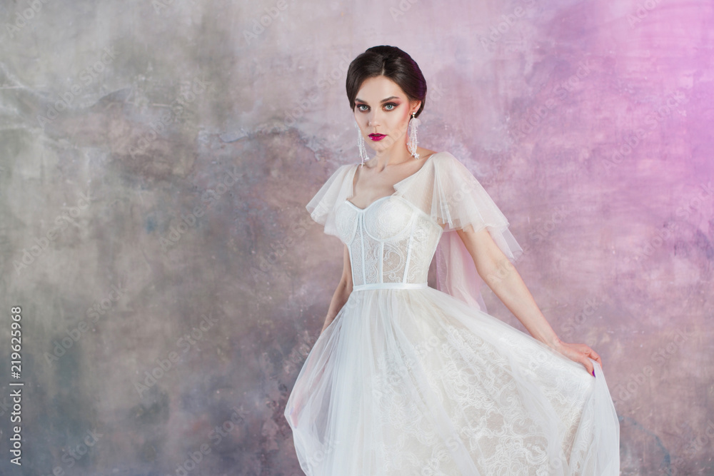 Beautiful and stylish bride in wedding dress in Studio Beautiful and stylish bride in wedding dress in Studio