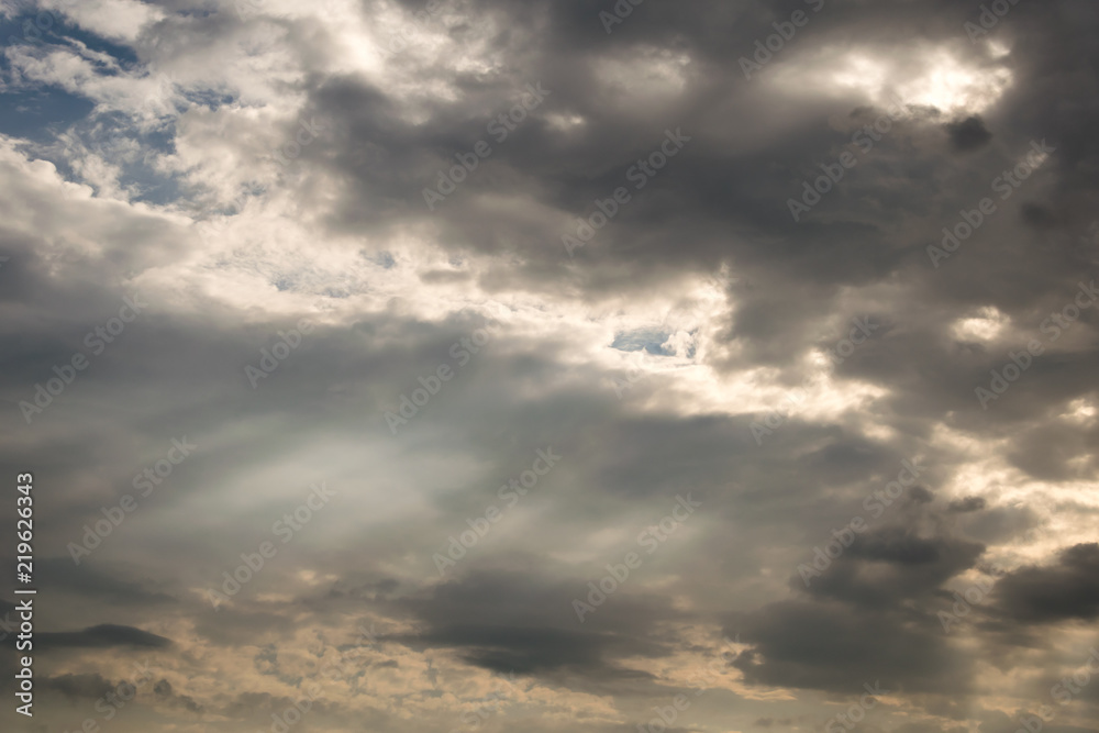 rays of the sun through dark clouds