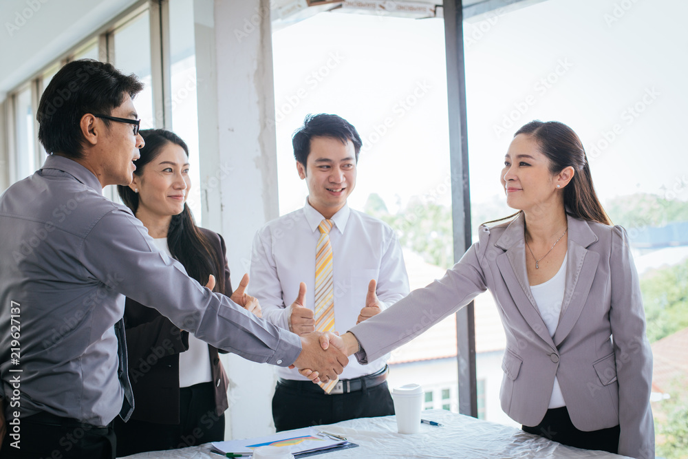 Working as a group - Group of business congratulate them on their cooperation after the meeting to collaborate on the project. Working as a group - Group of business congratulate them on their cooperation after the meeting to collaborate on the project.