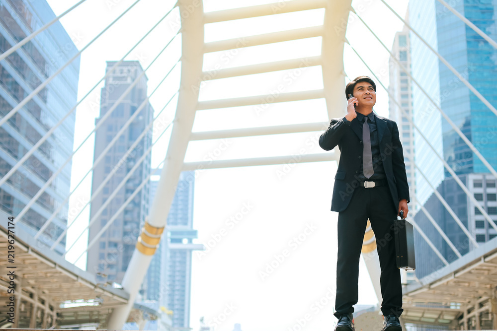 Professional business people interact with their clients with a mobile phone in his hands,He is credible and successful at work. Professional business people interact with their clients with a mobile phone in his hands,He is credible and successful at work.