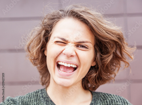 Young beautiful emotional funny joyful happy young woman, head shot