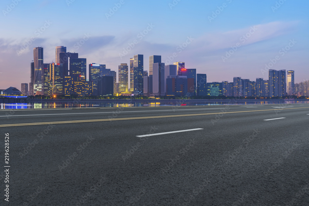 Urban road asphalt pavement and skyline of Hangzhou architectural landscape