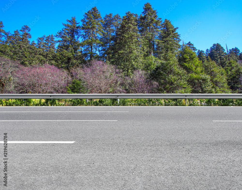 Asphalt highway and virgin forest landscape in Yunnan Province, China Asphalt highway and virgin forest landscape in Yunnan Province, China
