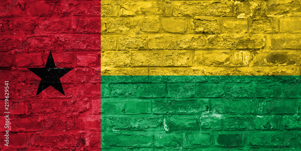 Flag of Guinea Bissau over an old brick wall background, surface