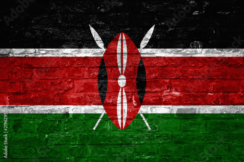 Flag of Kenya over an old brick wall background, surface