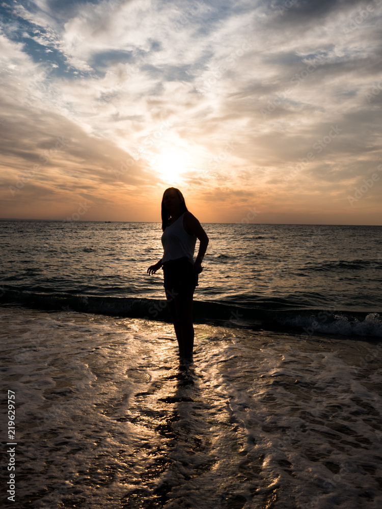 Woman relaxing at the beach during beautiful sunset. Vacation human relaxation