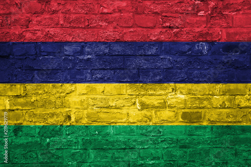 Flag of Mauritius over an old brick wall background, surface