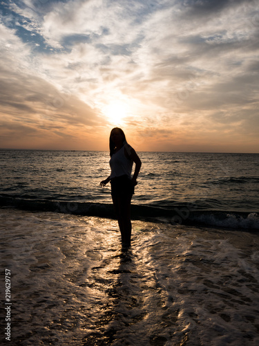 Woman relaxing at the beach during beautiful sunset. Vacation human relaxation © DC Studio