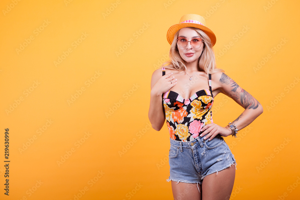 Sexy blonde babe in swimsuit with hat and sunglasses in studio Stock Photo  | Adobe Stock