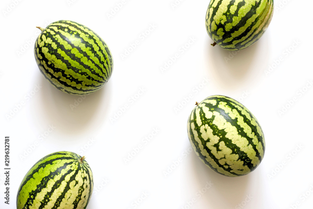 Bright summer white background with watermelons. Flat lay Bright summer white background with watermelons. Flat lay