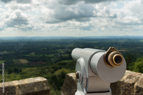 Looking out from a telescope view point across the Surrey and Sussex countryside from the North Downs to the South Downs. Taken from the top of Leith Hill Tower in England, UK, on a cloudy day.