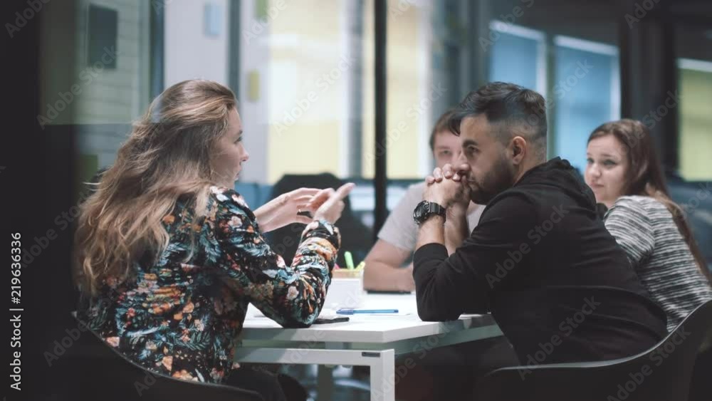 Portrait of young business team at work. Bright contemporary small creative business. Casual young people in new creative business office or architects company.