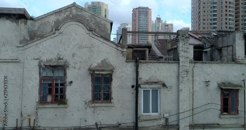 One of the very few remaining old Shanghai style residential areas shortly before its demolition, to make way for more high-rise development, such as those seen in the background. Part 1 of 3. photo