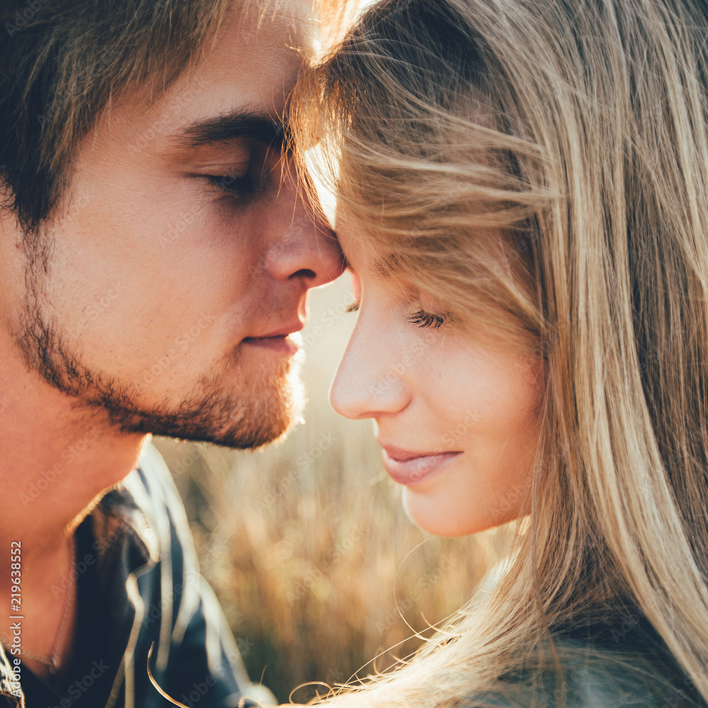Young happy couple hugging and laughing. Space for text. Close-up. Young happy couple hugging and laughing. Space for text. Close-up.
