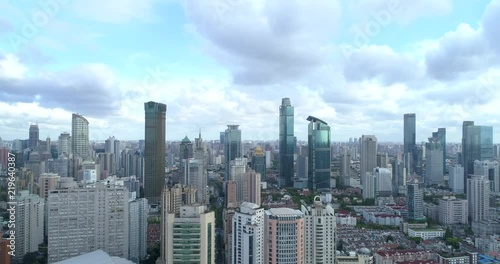 Ascending drone flight showing cityscape of modern megacity with highly populated build environment.  Jing'an District shown in the foreground is one of the central districts of Shanghai. 