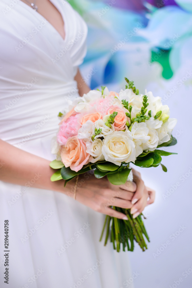 Wedding bouquet in the hands of the bride closeup Wedding bouquet in the hands of the bride closeup