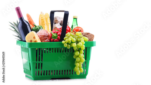 Plastic shopping basket with assorted grocery products photo