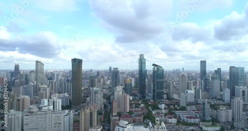 Ascending drone flight showing cityscape of modern megacity with highly populated build environment.  Jing'an District shown in the foreground is one of the central districts of Shanghai.  photo