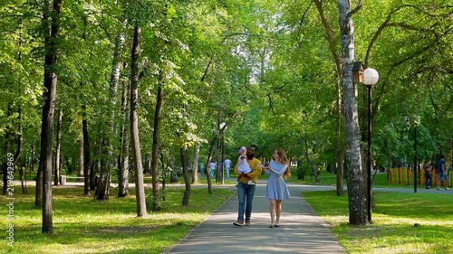 Wallpaper Mural Happy family walking in the summer Park. Go towards the camera Torontodigital.ca