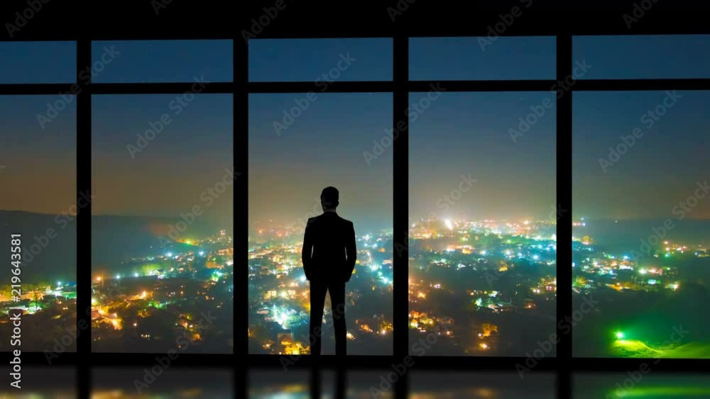 The man standing near panoramic windows on the foggy city background. time lapse The man standing near panoramic windows on the foggy city background. time lapse